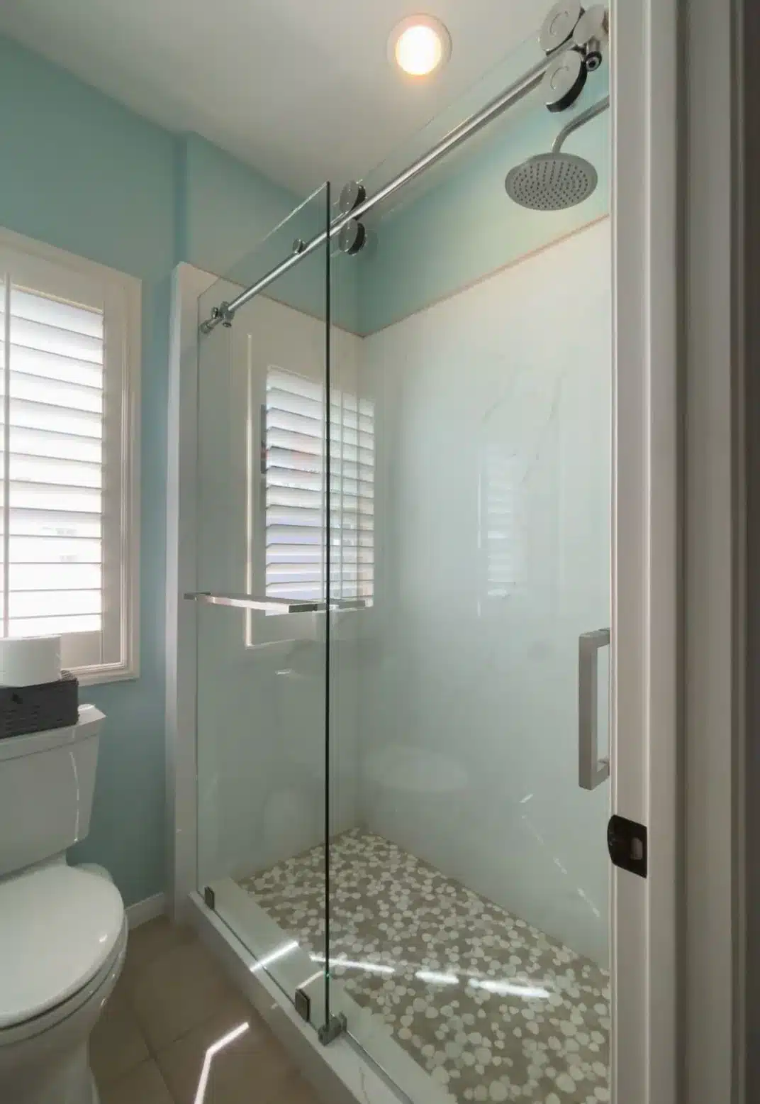 Chrome-hardware frameless Euroglide shower door in a bright San Clemente bathroom